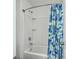 Simple bathroom with a white tub and a blue floral shower curtain at 1455 Red Tide Rd, Mount Pleasant, SC 29466
