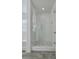 Bright bathroom boasts a large glass shower, marble shower floor, and modern vanity at 1455 Red Tide Rd, Mount Pleasant, SC 29466