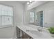 Clean bathroom with a modern vanity, mirror, and white cabinets at 1455 Red Tide Rd, Mount Pleasant, SC 29466