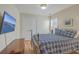 Bedroom with a blue and white quilt, hardwood floors, and a large TV at 1455 Red Tide Rd, Mount Pleasant, SC 29466