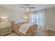 Charming bedroom with a floral comforter, hardwood floors, and a ceiling fan at 1455 Red Tide Rd, Mount Pleasant, SC 29466