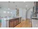 Modern kitchen with island, stainless steel appliances, and hardwood floors at 1455 Red Tide Rd, Mount Pleasant, SC 29466