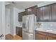 Stainless steel refrigerator in a modern kitchen with wood cabinets at 1455 Red Tide Rd, Mount Pleasant, SC 29466