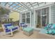 Relaxing patio with white rocking chairs, teal ottoman, and outdoor seating at 1455 Red Tide Rd, Mount Pleasant, SC 29466