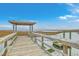 Wooden dock with a covered seating area overlooking calm waters at 1455 Red Tide Rd, Mount Pleasant, SC 29466