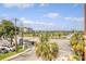 Aerial view of a neighborhood with palm trees, roads, and waterfront in the distance at 150 Bee St # 318, Charleston, SC 29401