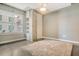 Bedroom with large window, neutral walls, and polished concrete floors at 150 Bee St # 318, Charleston, SC 29401