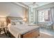 Bedroom with a rustic wooden bed frame and built-in shelving at 150 Bee St # 318, Charleston, SC 29401