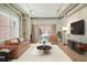 Spacious living room with exposed beams, large windows, and a view of a patio at 150 Bee St # 318, Charleston, SC 29401