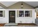 Dark brown front door with sidelights and shutters at 1558 Burnswick Dr, Johns Island, SC 29455