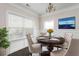 Elegant dining room features a round table with four chairs, and large window at 1617 Jessamine Rd, Charleston, SC 29407