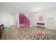 Chic basement with pink wall, seating area, and upstairs view at 1669 Indy Dr, North Charleston, SC 29405