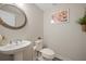 Small modern bathroom with pedestal sink, toilet and decorative mirror at 1669 Indy Dr, North Charleston, SC 29405