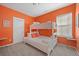 Bright bedroom with a bunk bed and orange walls at 1669 Indy Dr, North Charleston, SC 29405