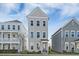 Three-story townhome with gray siding and a charming front porch at 1669 Indy Dr, North Charleston, SC 29405