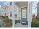 Front entrance of the townhome with gray door and porch at 1669 Indy Dr, North Charleston, SC 29405