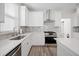 Modern kitchen with white cabinets, quartz counters and stainless steel appliances at 1669 Indy Dr, North Charleston, SC 29405