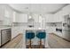Bright white kitchen with center island and stainless steel appliances at 1669 Indy Dr, North Charleston, SC 29405