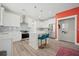 Modern white kitchen with island, stainless steel appliances, and teal barstools at 1669 Indy Dr, North Charleston, SC 29405