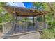 Relaxing gazebo with wooden benches and ceiling fan, overlooking a pond at 188 Midland Pkwy # 205, Summerville, SC 29485