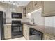 Well-equipped kitchen featuring granite countertops and black appliances at 188 Midland Pkwy # 205, Summerville, SC 29485