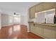 Hardwood floor living room with kitchen bar and window at 188 Midland Pkwy # 205, Summerville, SC 29485