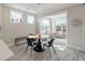 Cozy dining area featuring a modern chandelier and a view into a sunny sitting room at 200 Clearblue Loop, Summerville, SC 29486