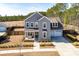 Charming two-story home with a covered porch and swing, complemented by a well-manicured lawn at 200 Clearblue Loop, Summerville, SC 29486