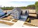 Two-story home with a gray exterior, manicured lawn, an attached two-car garage, and a charming front porch swing at 200 Clearblue Loop, Summerville, SC 29486