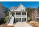 Two-story house with a front porch, two-car garage, and landscaping at 2084 Amenity Park Dr, Mount Pleasant, SC 29466