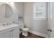 Small powder room with white vanity and window at 2084 Amenity Park Dr, Mount Pleasant, SC 29466