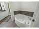 Modern bathroom with a soaking tub and tiled floors at 21 George St # 114, Charleston, SC 29401