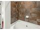 Clean bathroom with a shower/tub combo and tile surround at 21 George St # 114, Charleston, SC 29401
