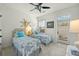 Bright bedroom with two twin beds, and access to a private patio at 21 George St # 114, Charleston, SC 29401
