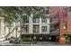 Brick building exterior with gated parking and tree-lined street at 21 George St # 114, Charleston, SC 29401