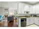 Bright kitchen with white cabinets, granite countertops, and stainless steel appliances at 21 George St # 114, Charleston, SC 29401
