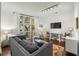 Living room with hardwood floors, large windows, and comfortable seating at 21 George St # 114, Charleston, SC 29401