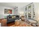 Living room with hardwood floors, large windows, and comfortable seating at 21 George St # 114, Charleston, SC 29401