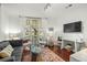 Living room with hardwood floors, large windows, and comfortable seating at 21 George St # 114, Charleston, SC 29401
