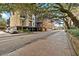 Building exterior on tree lined street with brick sidewalks at 21 George St # 114, Charleston, SC 29401