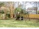 Playset in grassy backyard, surrounded by trees and fence at 212 Thomaston Ave, Summerville, SC 29485