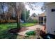 Landscaped backyard with patio, shed, and mature trees at 212 Thomaston Ave, Summerville, SC 29485