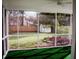 View from screened porch showcasing backyard and wooden fence at 212 Thomaston Ave, Summerville, SC 29485