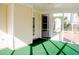 Bright screened porch with green flooring and backyard access at 212 Thomaston Ave, Summerville, SC 29485