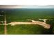 Expansive aerial view of a new home community's construction near lush green forests and a water feature at 215 Terrace View Dr, Summerville, SC 29486