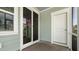 Covered porch features a sliding glass door and door to the yard on the side of a home at 215 Terrace View Dr, Summerville, SC 29486