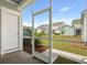 The view from the screened-in porch shows houses and landscaping in the backyard at 215 Terrace View Dr, Summerville, SC 29486