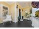 Inviting front porch with white wicker chair and plants at 217 Old Hickory Xing, Johns Island, SC 29455