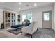 Living room with light-colored sofa and blue velvet ottoman at 221 Terrace View Dr, Summerville, SC 29486