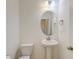 Simple bathroom with pedestal sink, oval mirror, and toilet at 234 Swamp Creek Ln, Moncks Corner, SC 29461